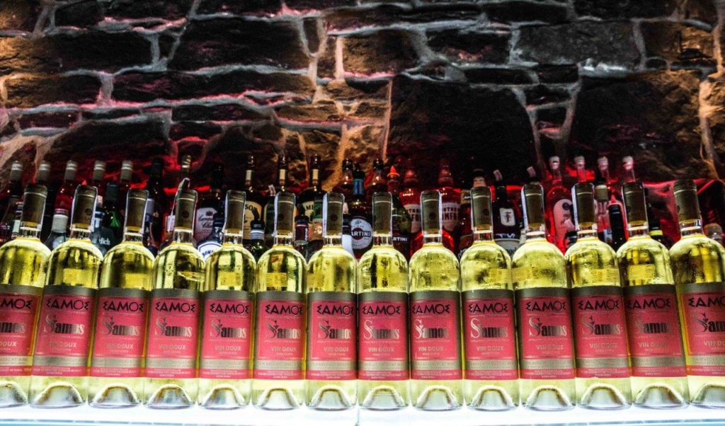 A row of samos wine bottles on a table