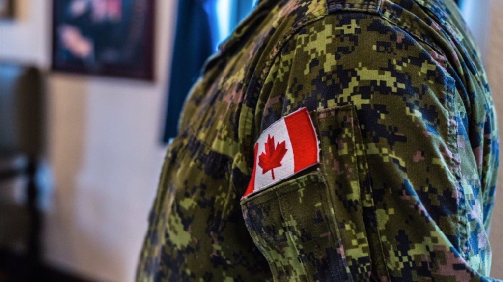 A close up of a canadian flag on a military uniform